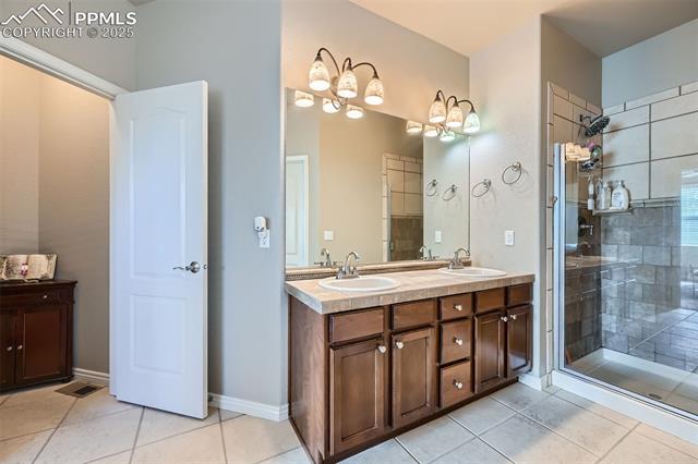 2553 Cinnabar Road Colorado Springs, CO 80921 - Photo 16 of 27 Master bathroom with dual vanity and large walk-in shower