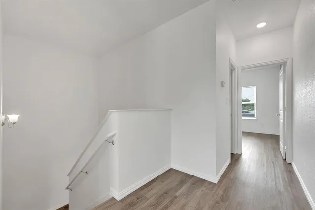 a view of a room with wooden floor