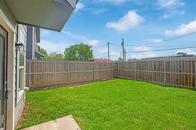 a view of a backyard with a fence