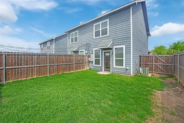 a view of a backyard with wooden fence