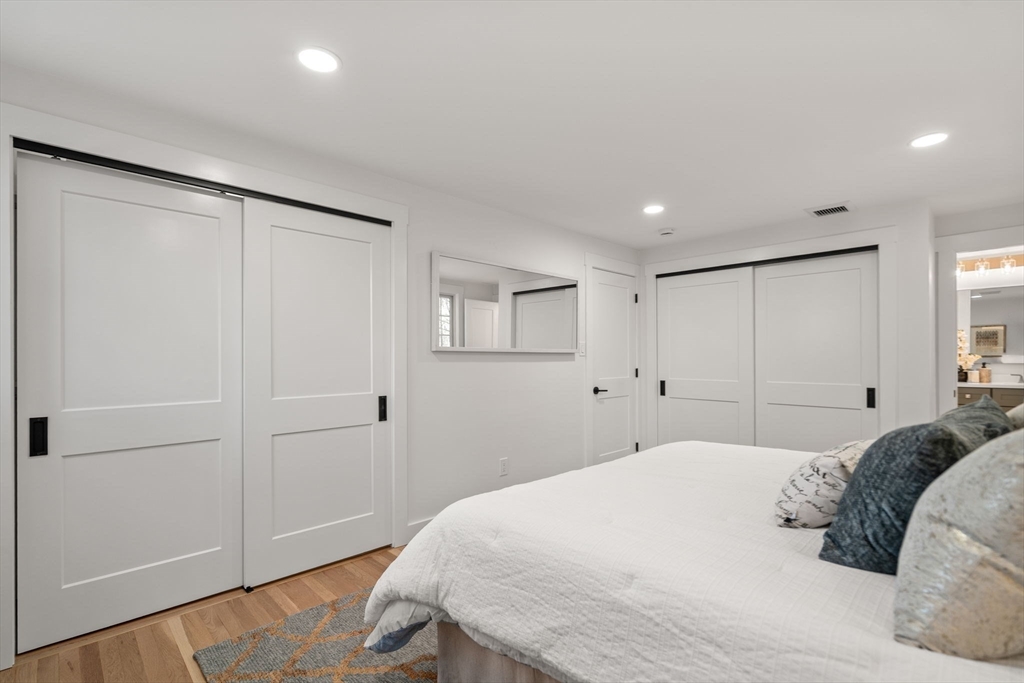 59 Tanbark Road Sudbury, MA 01776 - Photo 23 of 42 a bedroom with a large bed and hardwood floor