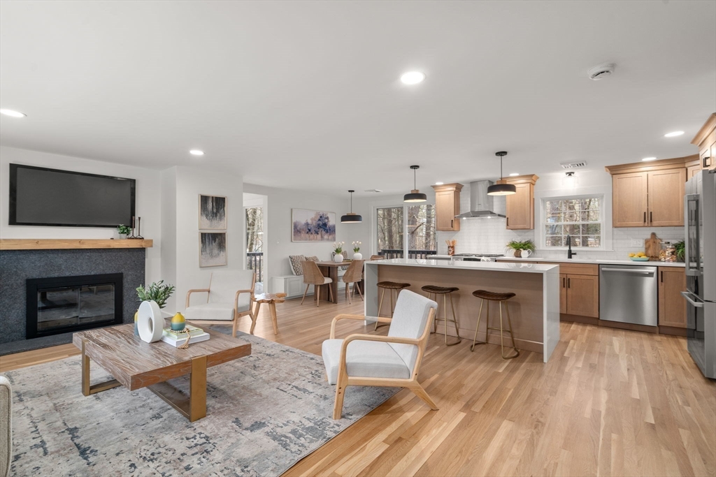 59 Tanbark Road Sudbury, MA 01776 - Photo 6 of 42 a living room with stainless steel appliances furniture a fireplace a rug and a view