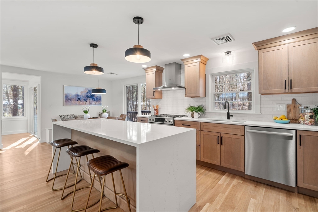 59 Tanbark Road Sudbury, MA 01776 - Photo 9 of 42 a kitchen with stainless steel appliances a sink a stove and chairs