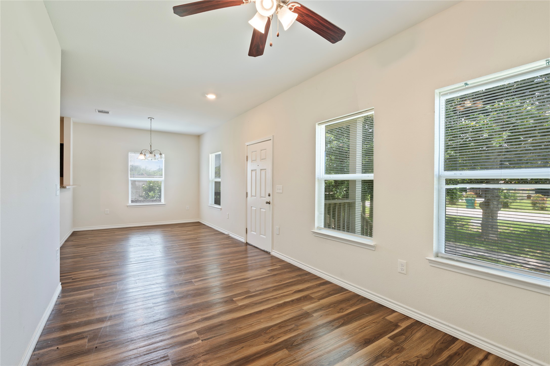 1125 Lake Road La Marque, TX 77568 - Photo 9 of 33 a view of an empty room with wooden floor and a window