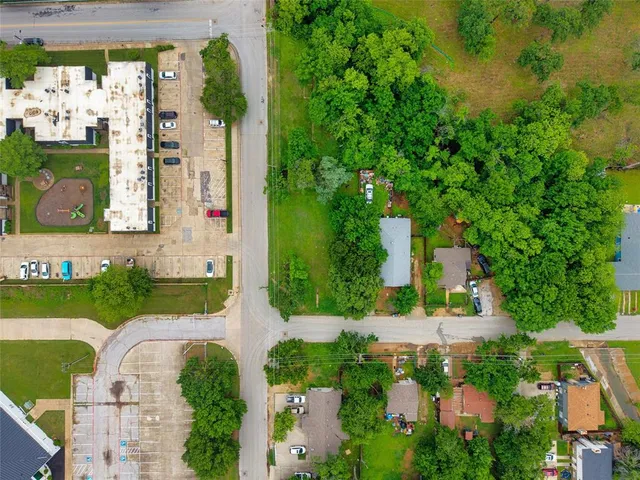 an aerial view of a house with a yard basket ball court and outdoor seating