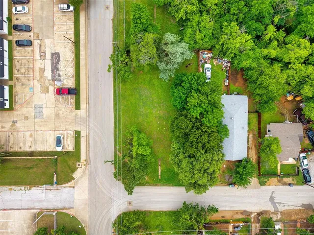 an aerial view of a house with a yard and lake view