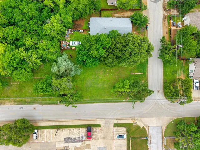 an aerial view of a house with a yard basket ball court and outdoor seating