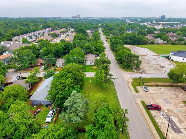 an aerial view of residential houses with outdoor space and street view