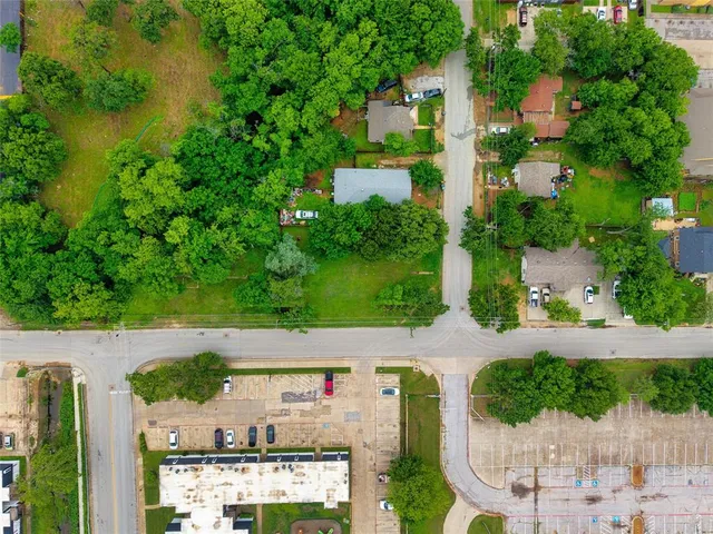 an aerial view of a house with a yard and lake view