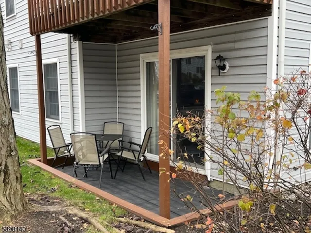 a view of a patio with table and chairs and potted plants