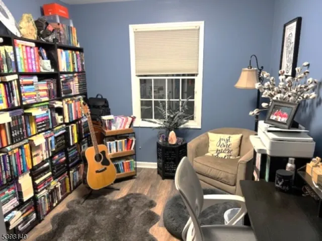 a living room with fireplace furniture and a book shelf