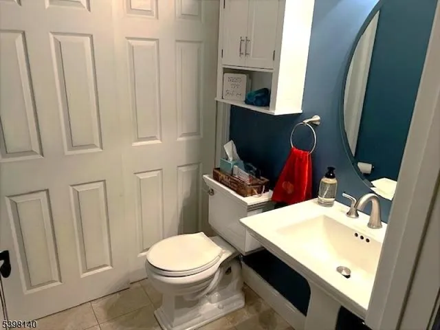 a bathroom with a sink toilet and mirror