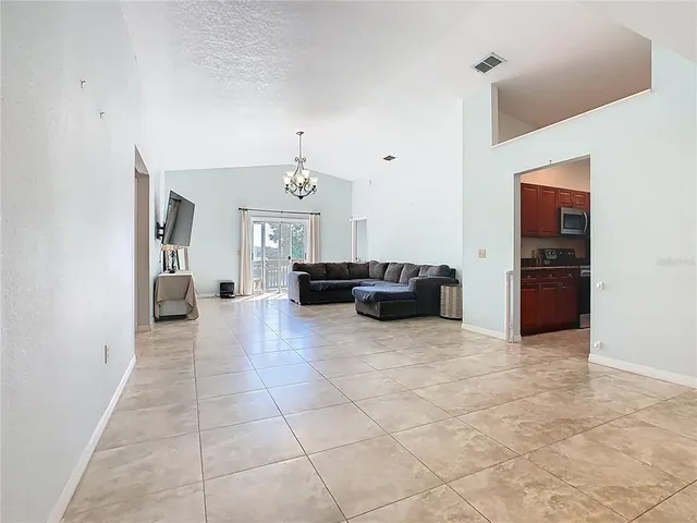 a living room with furniture and a chandelier