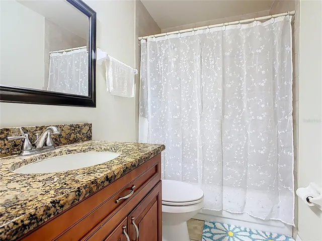 a bedroom with a bed and a chandelier fan