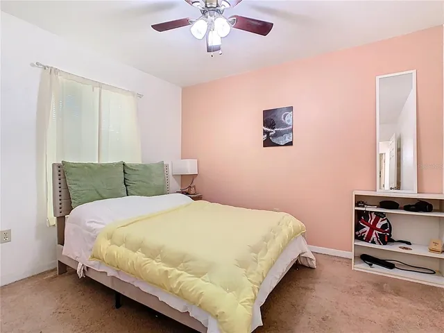 a bedroom with a bed and a tv