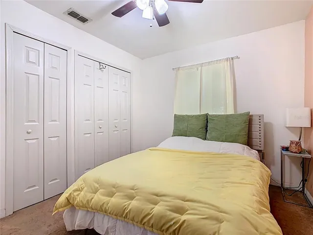 a view of a bedroom with a bed and a chandelier