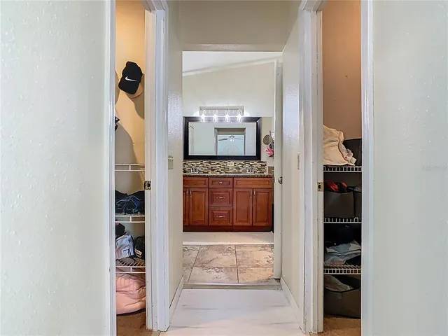 a bathroom with a granite countertop shower a sink and a mirror