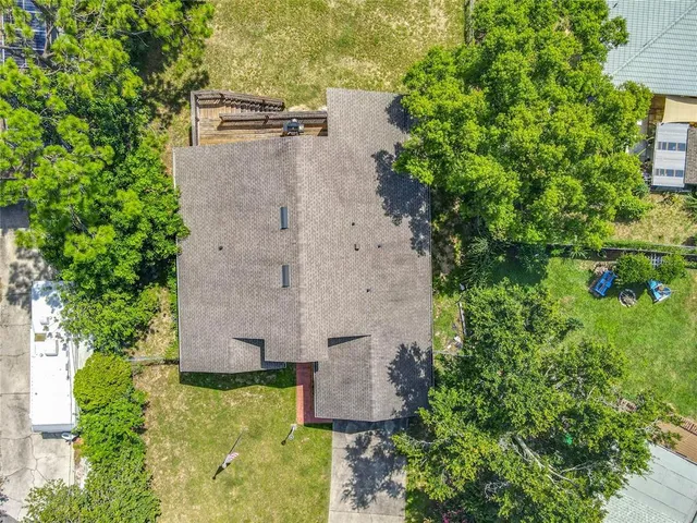 an aerial view of residential houses with outdoor space and swimming pool
