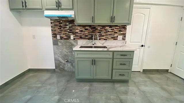 a kitchen with a stove and a refrigerator