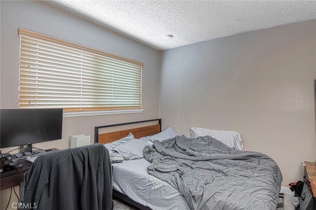 209 Walnut Street Newport Beach, CA 92663 - Photo 11 of 30 a bedroom with a bed and two windows