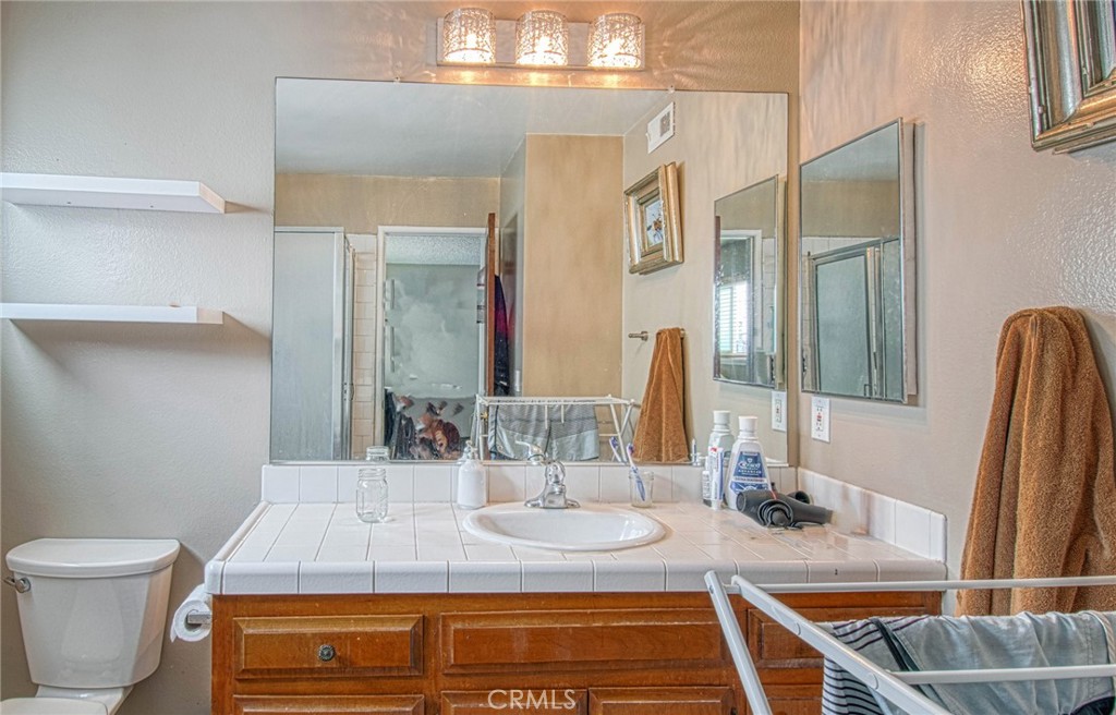 209 Walnut Street Newport Beach, CA 92663 - Photo 13 of 30 a bathroom with a granite countertop sink and a mirror