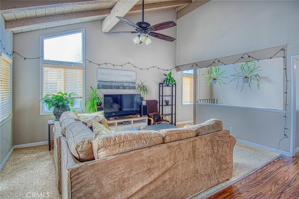 209 Walnut Street Newport Beach, CA 92663 - Photo 19 of 30 a living room with furniture a fireplace and a chandelier