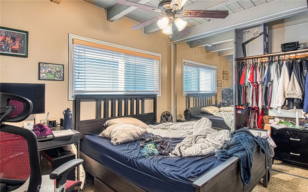 209 Walnut Street Newport Beach, CA 92663 - Photo 23 of 30 a bedroom with a bed and a chandelier