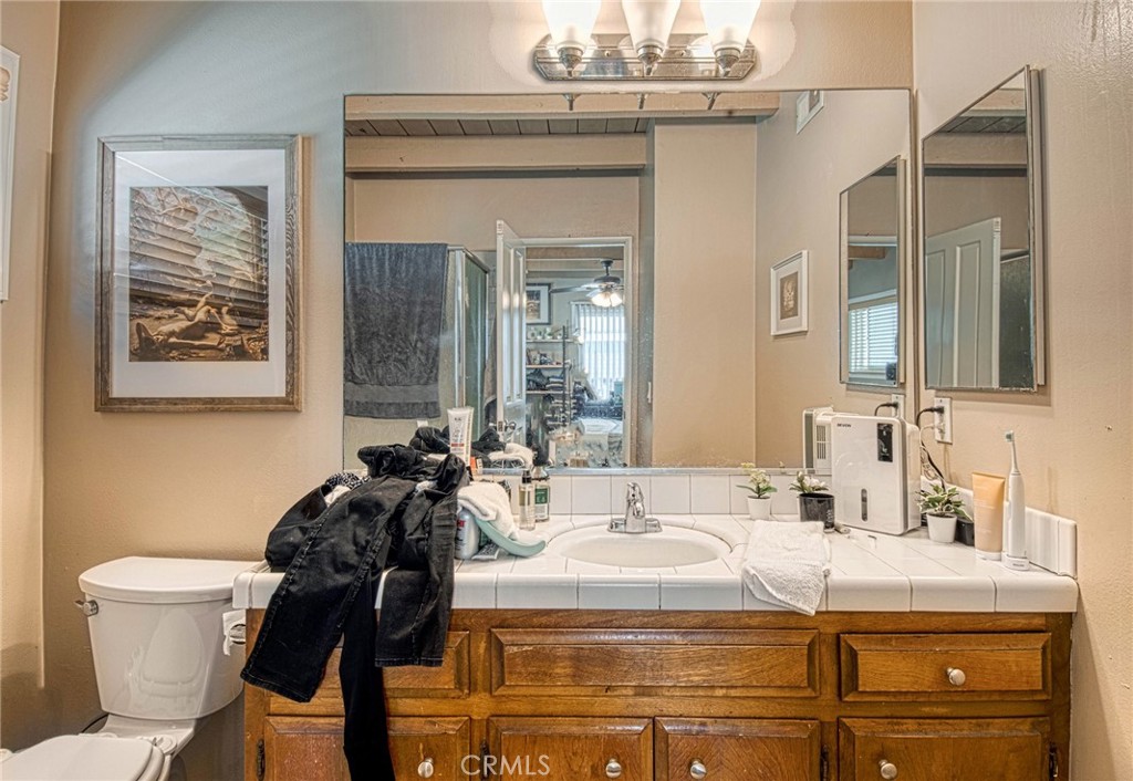 209 Walnut Street Newport Beach, CA 92663 - Photo 25 of 30 a bathroom with a granite countertop sink a toilet and mirror