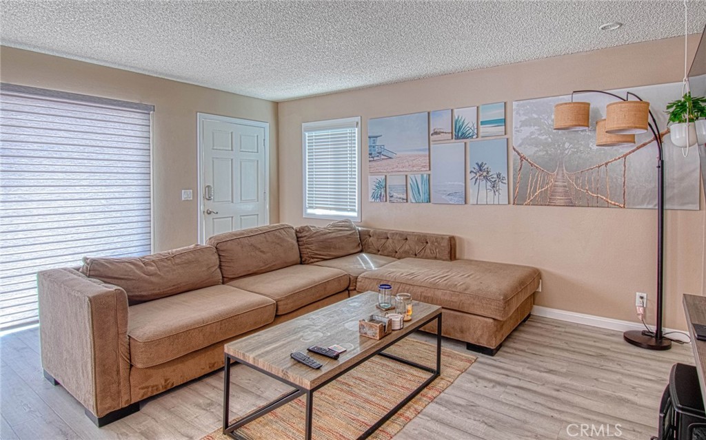 209 Walnut Street Newport Beach, CA 92663 - Photo 5 of 30 a living room with furniture and a wooden floor