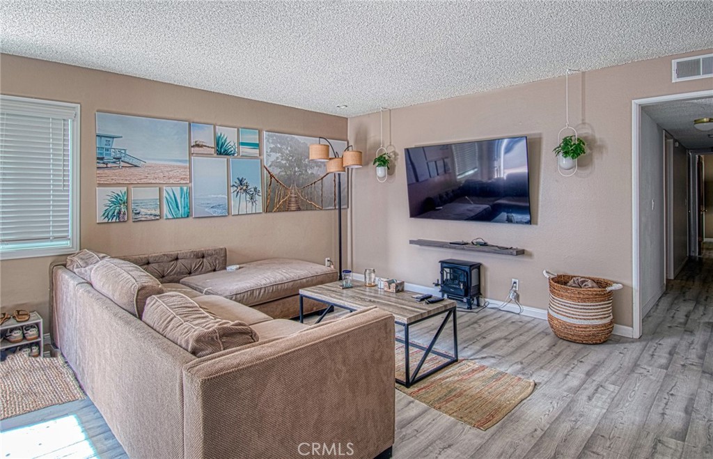 209 Walnut Street Newport Beach, CA 92663 - Photo 6 of 30 a living room with furniture and a flat screen tv