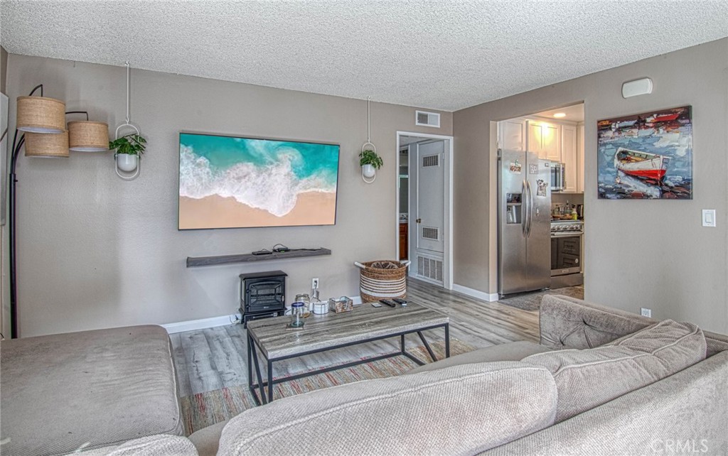 209 Walnut Street Newport Beach, CA 92663 - Photo 7 of 30 a living room with furniture and a flat screen tv