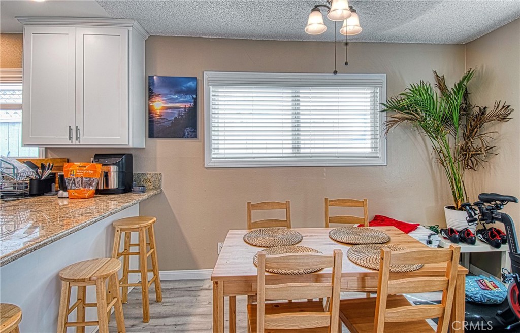 209 Walnut Street Newport Beach, CA 92663 - Photo 8 of 30 a kitchen with a table and chairs in it