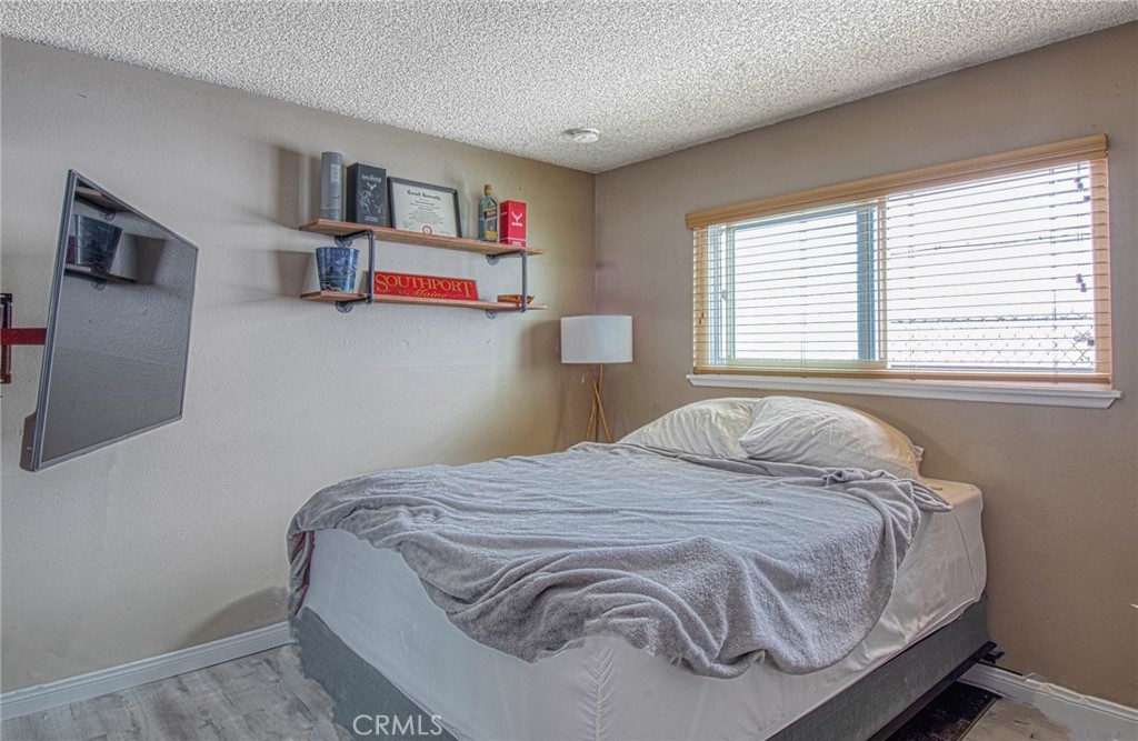 209 Walnut Street Newport Beach, CA 92663 - Photo 10 of 30 a bedroom with a bed and window