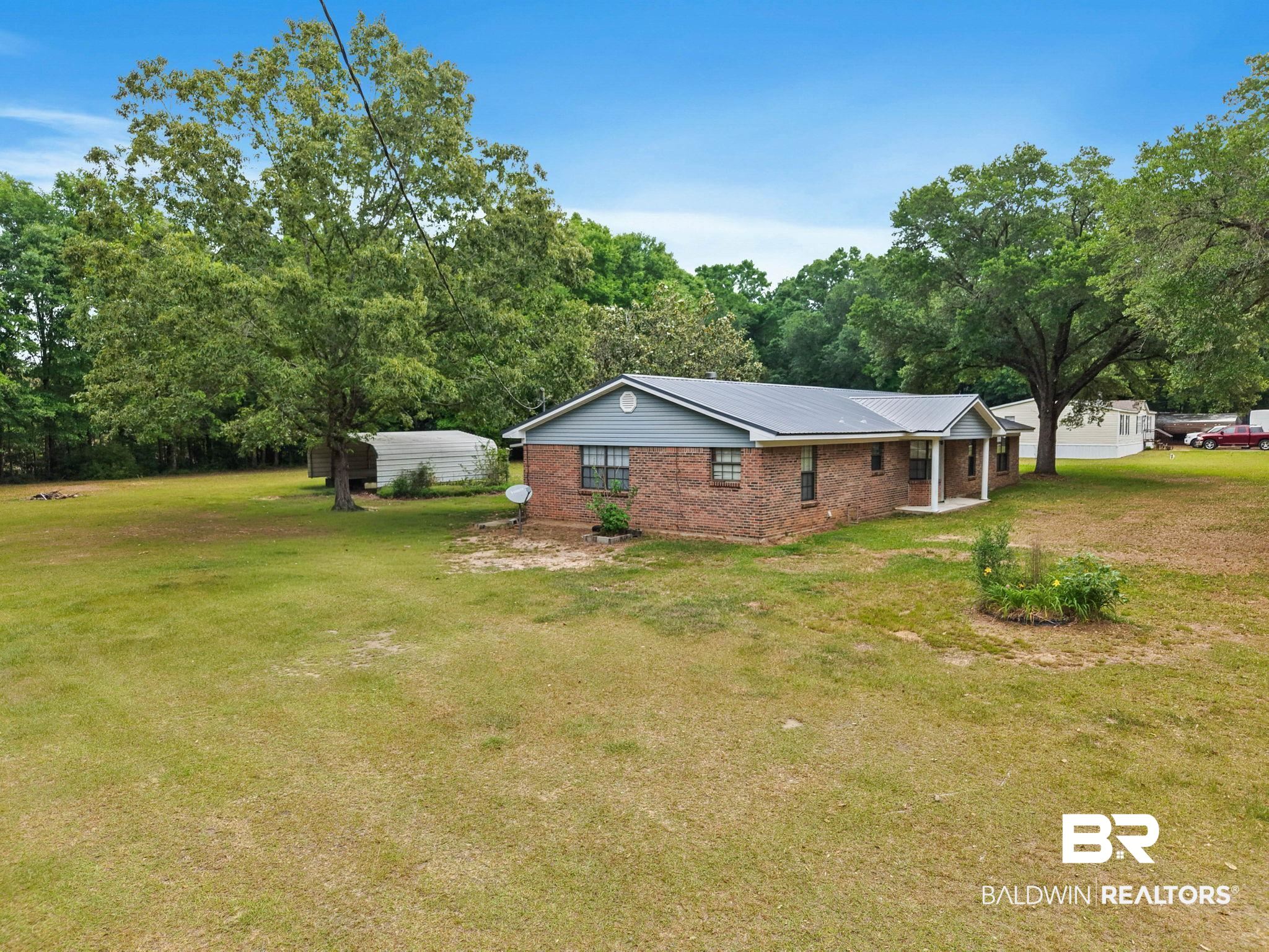 13653 Roberts Road Loxley, AL 36551 - Photo 26 of 33 Brick and siding exterior with a metal roof