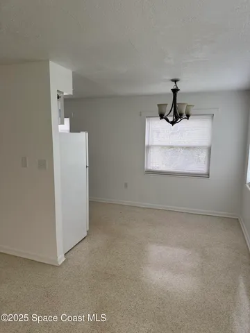 a view of empty room with ceiling fan