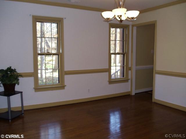 13614 Hunts Bridge Road Midlothian, VA 23112 - Photo 8 of 23 a view of an empty room with wooden floor and a window