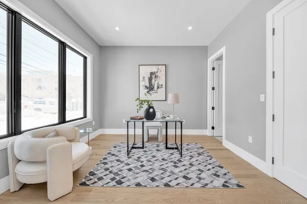 a living room with furniture rug and window