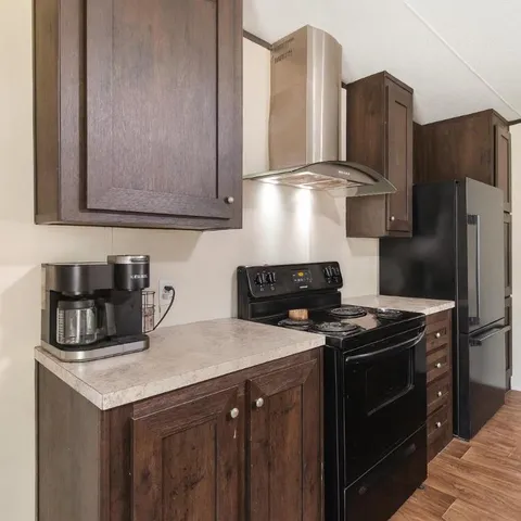 a kitchen with stainless steel appliances granite countertop a stove a refrigerator and a sink