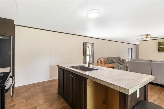a kitchen with a sink a refrigerator and a stove