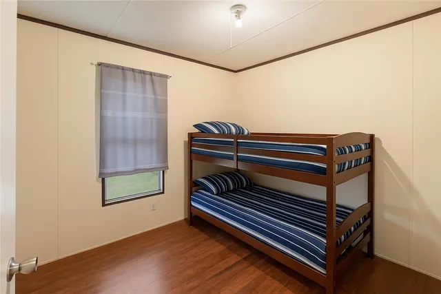a view of room with stairs and wooden floor