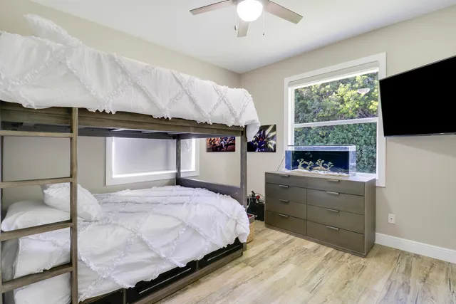 a bedroom with a bed and a television