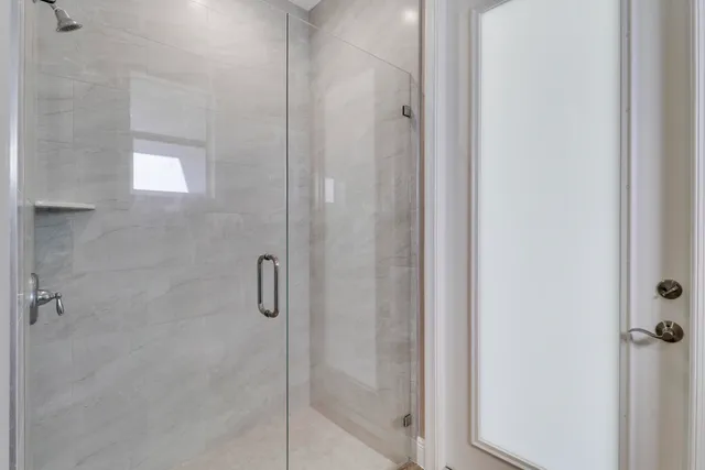 a bathroom with a glass shower door