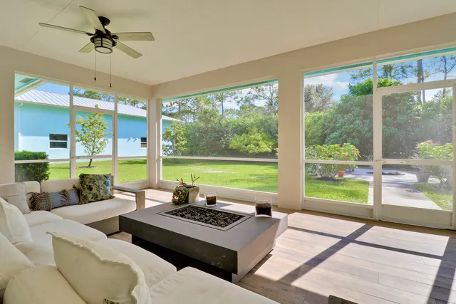a living room with furniture and large windows