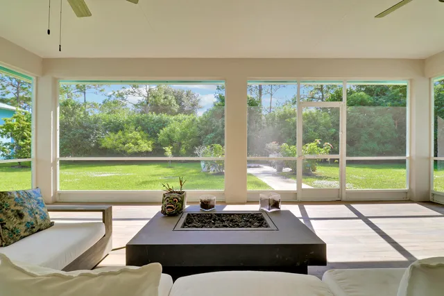a living room with a floor to ceiling window and a table