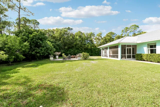 a house view with swimming pool and garden space