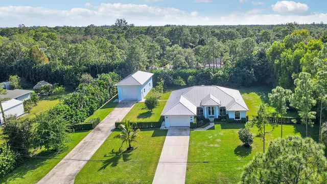 a view of yard with swimming pool and green space