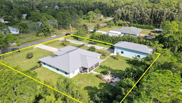 an aerial view of a house with a garden and swimming pool