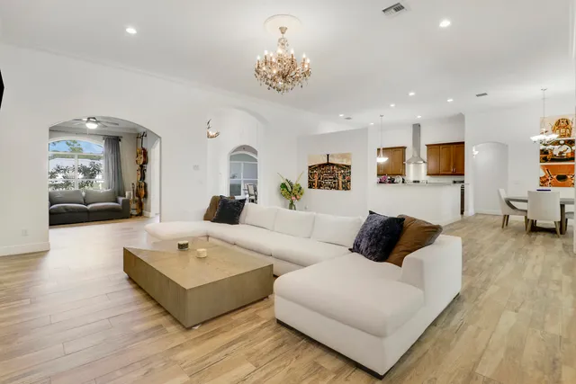 a living room with furniture and a chandelier
