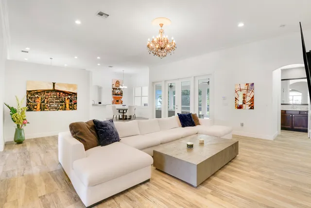 a living room with furniture and a chandelier