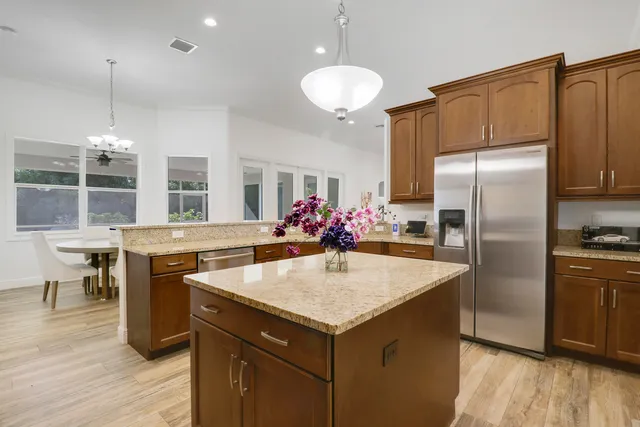 a kitchen with a refrigerator a sink and center island
